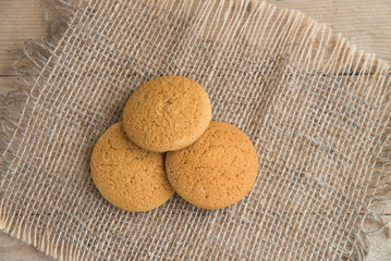 Stack of freshly baked oat biscuits on the background of burlap