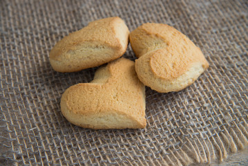 Cookies in the shape of heart on natural rustic background, homemade delicious