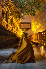 The resourceful monk, meditating at the temple (stupa) of Mahabodhi, under bodhi-tree, having completely taken cover from annoying mosquitoes in woolen cloak.