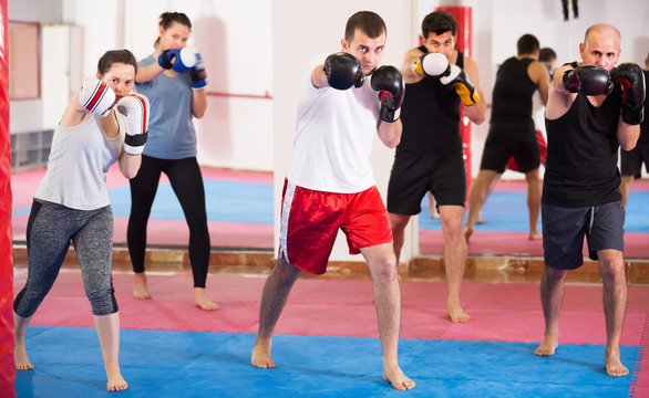 Friendly sportsmen practicing boxing punches