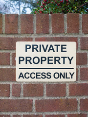 private property access only black and white sign on brick wall close up