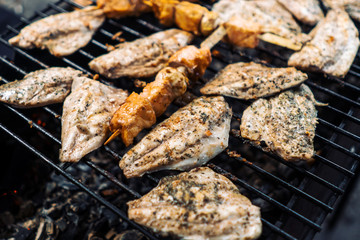 The fish is grilled, burning coals.