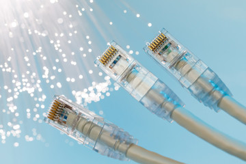 Closeup of RJ45 UTP LAN on the background of optical fibers with blurred lights