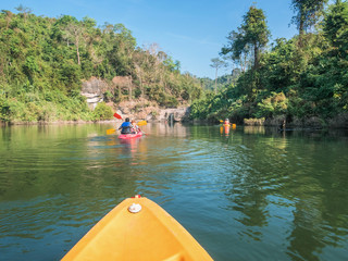 Tourists are kayaking to visit the waterfall in an atmosphere surrounded by mountains,places Wang...