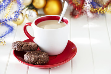 Chocolate oatmeal cookies with cup of coffee. Christmas concept. White wooden background.
