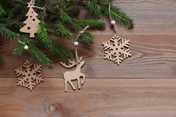Christmas background. Wooden figures on the fir branches