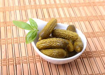 Pickles. Bowl of pickled gherkins cucumber with copy space. Cornichons.