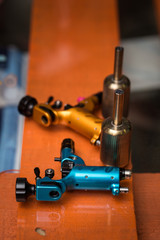 Machines for tattooing. Close-up. Blue and yellow.