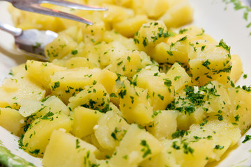 Side dish of boiled potatoes with parsley