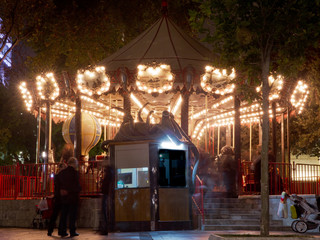 Fun fair and night. Beautiful bright carousel in park at night in winter