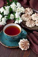 Fototapety  Composition with cookies, cup of tea  and jasmine flowers on wooden background