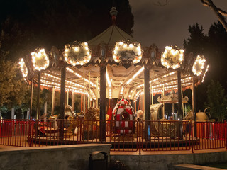 Fun fair and night . Colorful chain swing carousel in motion at amusement park