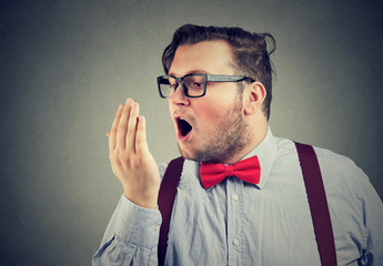 Man in glasses testing breath
