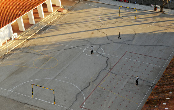 Children playing in the playground of a public elementary school at sunset, Portugal, Europe