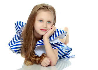 Adorable little blond girl in very short summer striped dress.Sh