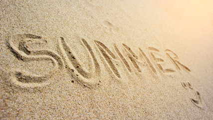 Fototapeta na wymiar Summer inscription on the sand