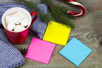 Blank colored sticky notes  ready for message and cup of coffee  with decoration on wooden board