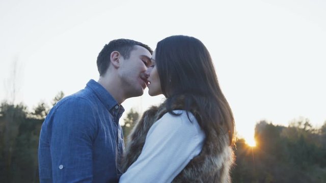 Romantic softly kiss of lovely couple on nature. 4K