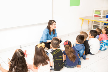 Preschoolers sitting in the classroom floor