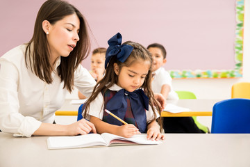 Teacher helping a student with an assigment