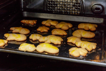 Baking christmas gingerbread cookies with hot oven.