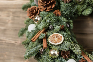 Beautiful Christmas wreath on wooden boards. Preparation for holidays concept. Flower shop is a...
