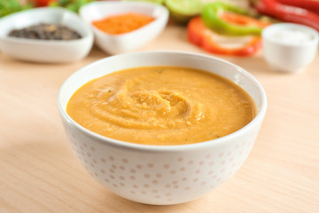 Bowl of homemade lentils creme soup on table, closeup