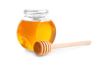 Jar of honey with dipper, isolated on white