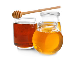 Jars with aromatic honey on white background