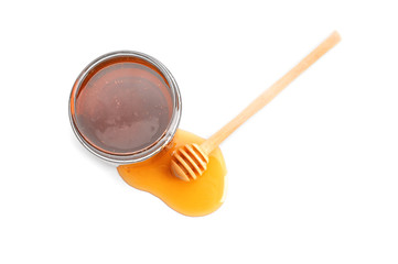 Jar of honey with dipper, isolated on white