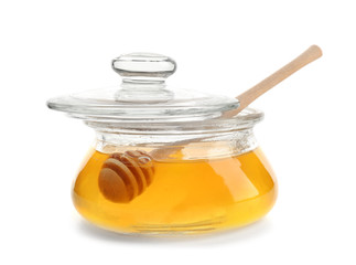 Jar of honey with dipper, isolated on white