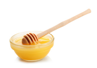 Bowl of aromatic honey with dipper, isolated on white