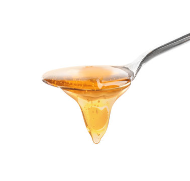 Spoon with honey, isolated on white