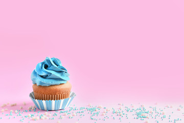 Delicious cupcake on color background