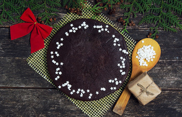 chocolate pie with tasty holiday Gingerbread Cookies on wooden table. Merry Christmas and Happy New Year card 