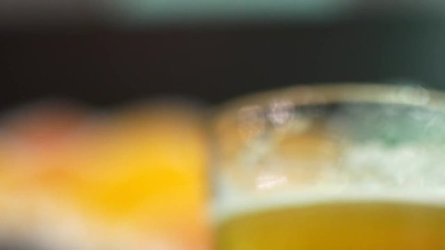 A glass of dark and light beer close-up. IPA and lagger in beer glasses. Friends are drinking beer in the bar