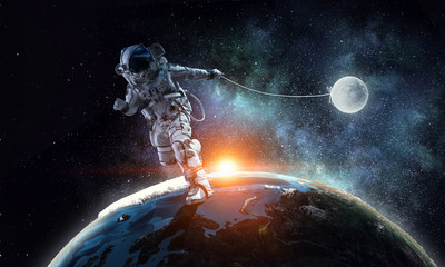 Fantasy image with spaceman catch planet. Mixed media
