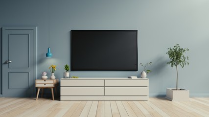 TV on the cabinet in modern living room on blue wall background,3d rendering