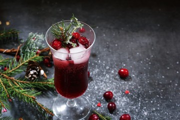 Holiday Drink Mulled wine with cranberries on xmas background , selective focus