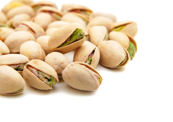 Stack of pistachios isolated on white background