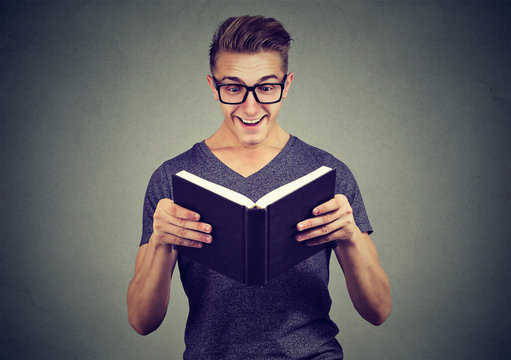 Excited man looking at book