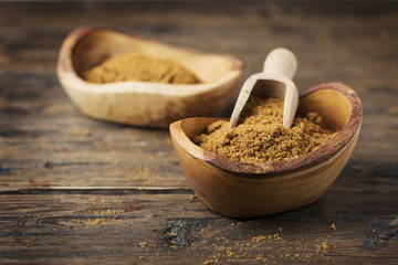 Brown sugar on wooden background