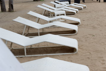 Fototapeta na wymiar Resting Chairs, Sand, Beach Front and Perfect Weather