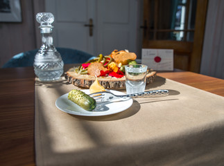 a glass of vodka with salted cucumber and a garlic