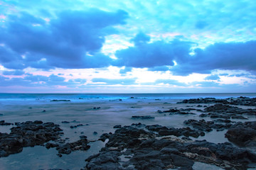 Empty beach around sunrise on a cloudy day at Sandy beach, Oahu, Hawaii