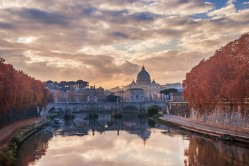 Saint Peter autumn sunset with River Tiber and red leaves in Rome