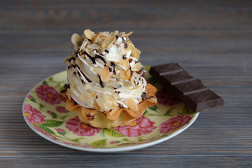 Delicious cupcake with cream on a wooden table