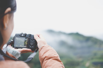 tourist use camera to take picture of mountain view. people, travel, nature concept.