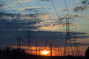 Power lines against a colorful sunset