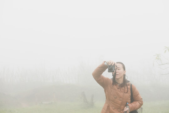 woman take photo in mist and fog. tourist take photo in forest.